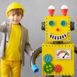 Happy child playing with robot